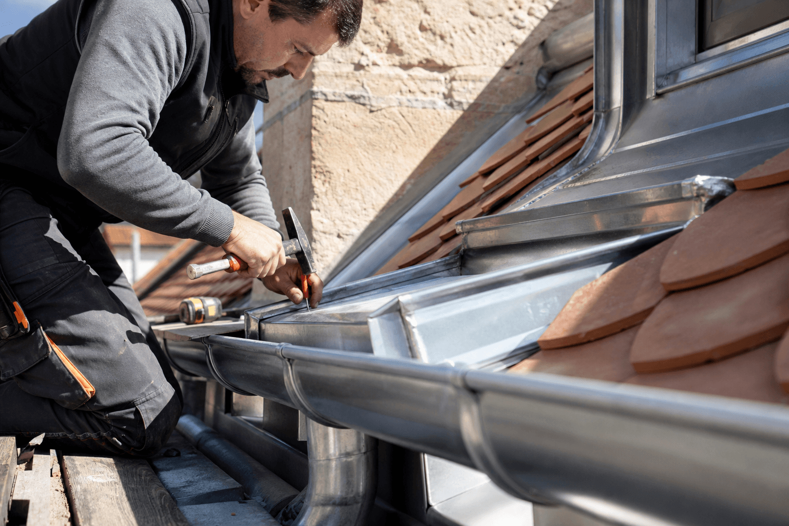 Travaux de zinguerie sur gouttière et raccord de toiture